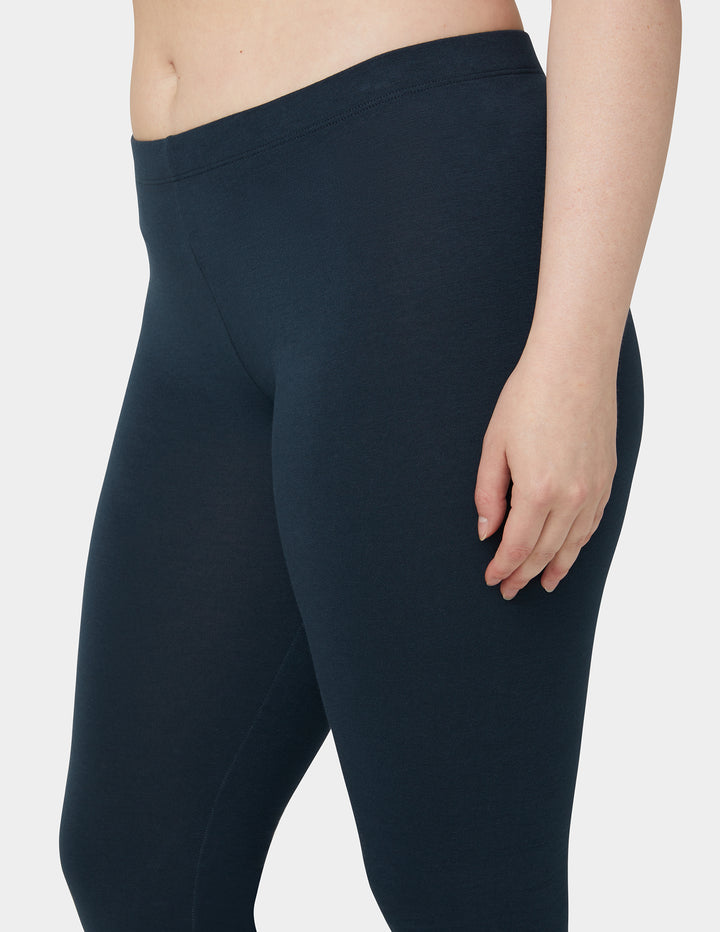 Navy leggings worn by a person on a plain background
