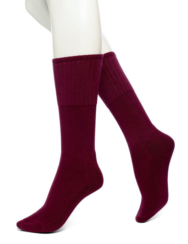 A pair of red crew-length boot socks on a mannequin