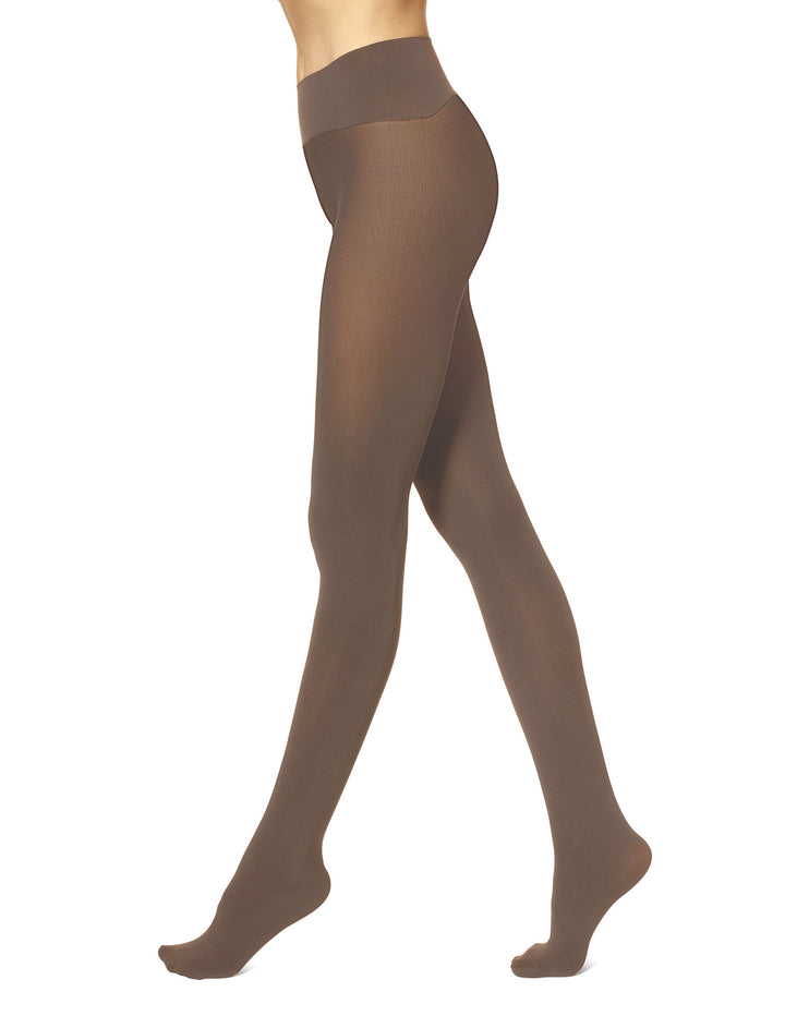 A model's legs wearing sheer taupe-brown hosiery tights, shown from the waist down against a plain white background.