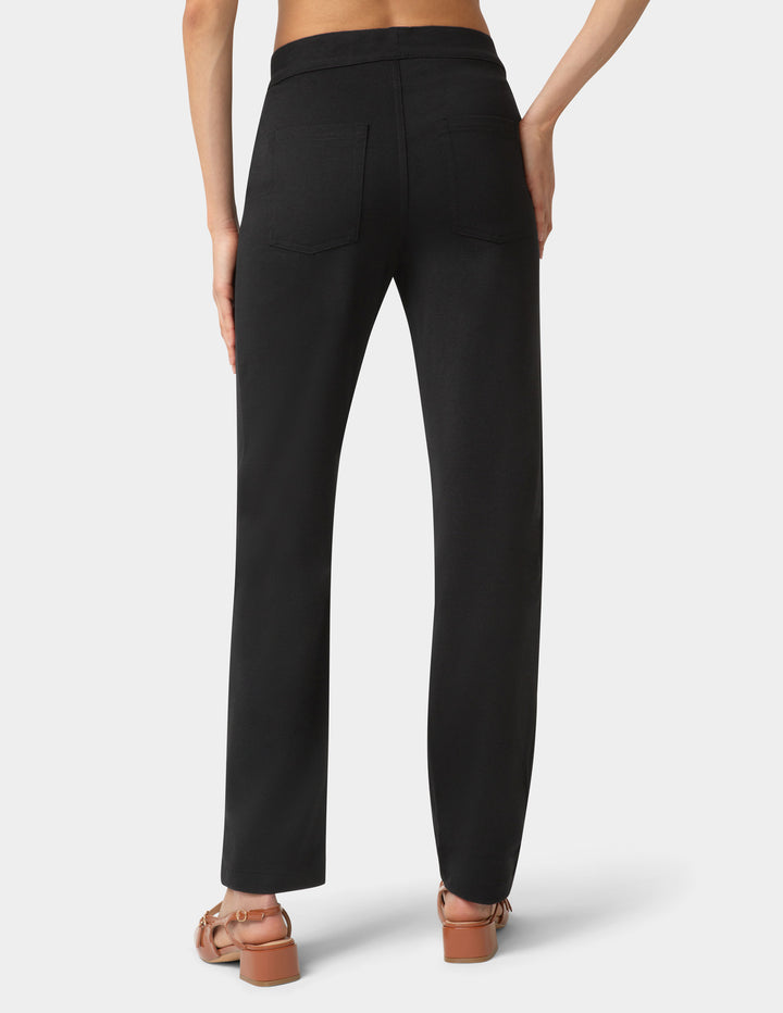 Black pants worn by a person on a white background