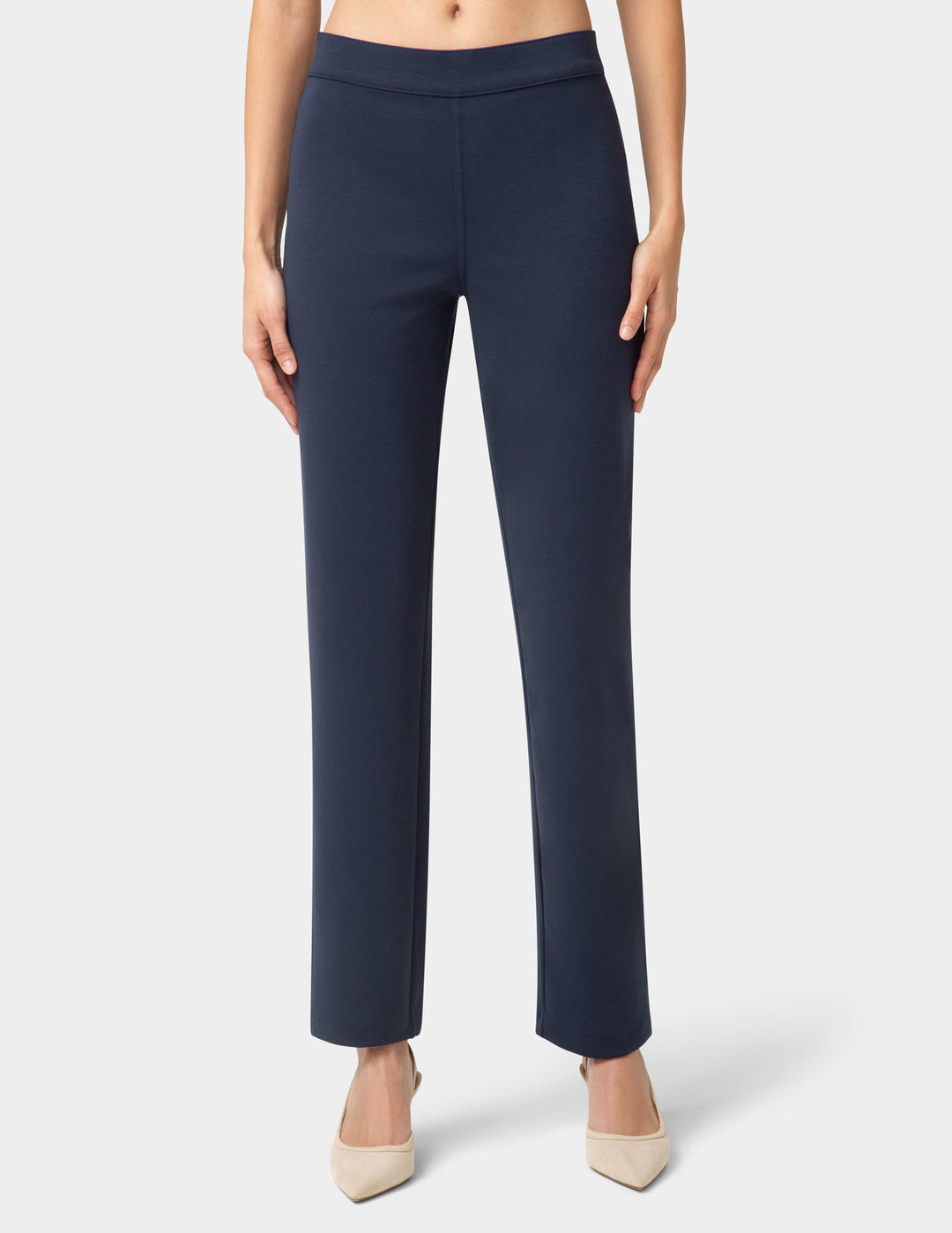 Navy blue pants worn by a person on a white background