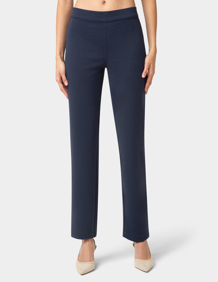 Navy blue pants worn by a person on a white background