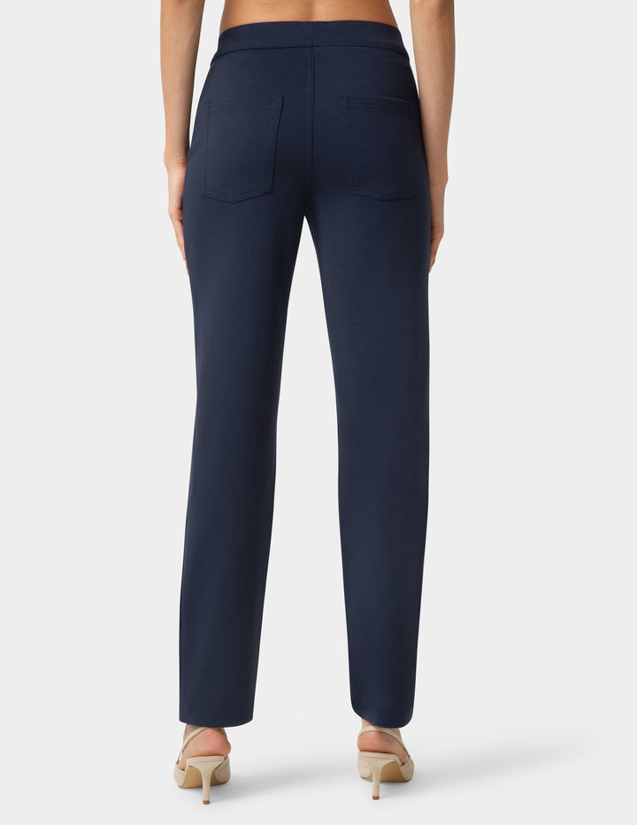 Navy blue pants worn by a person on a white background
