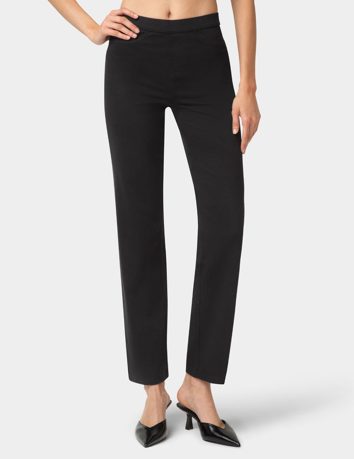 Black pants worn by a person on a white background