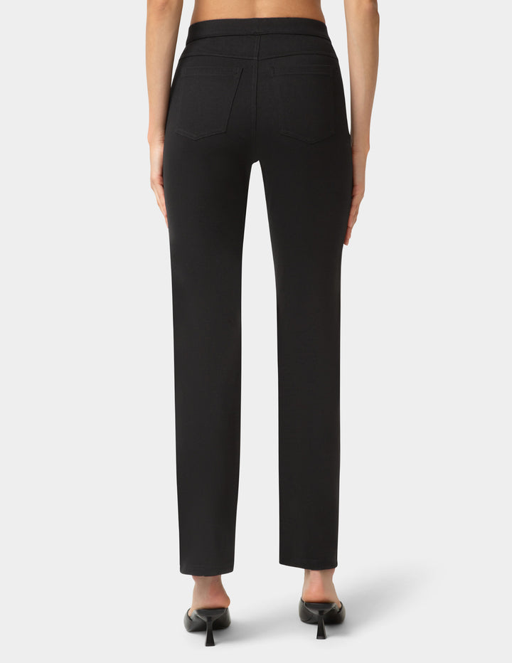 Black pants worn by a person on a white background