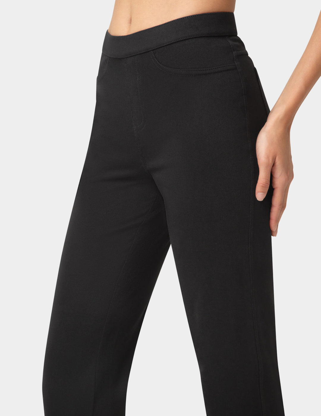 Black pants worn by a person on a white background