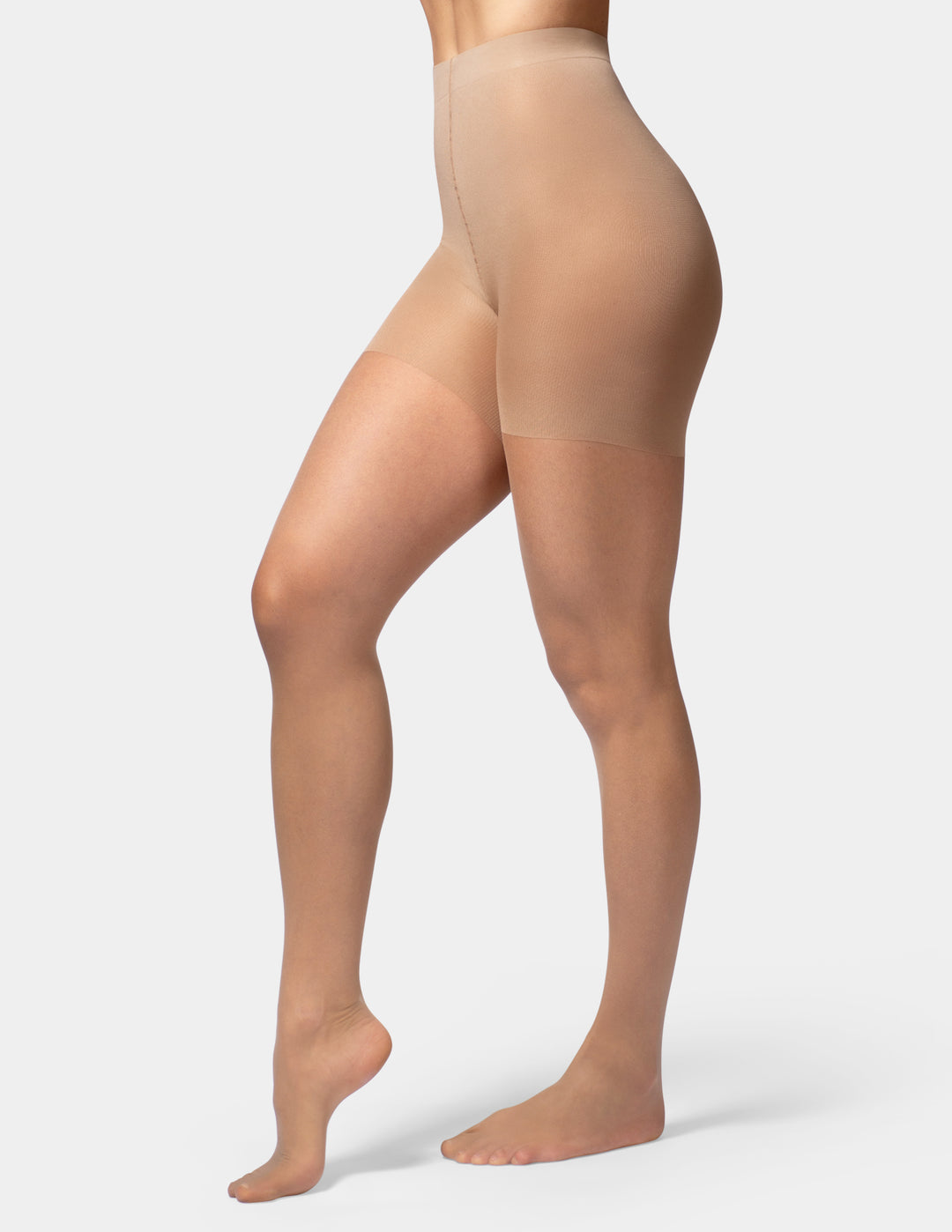 A model's legs and lower torso wearing sheer, high-waisted nude sheers against a light gray studio background.