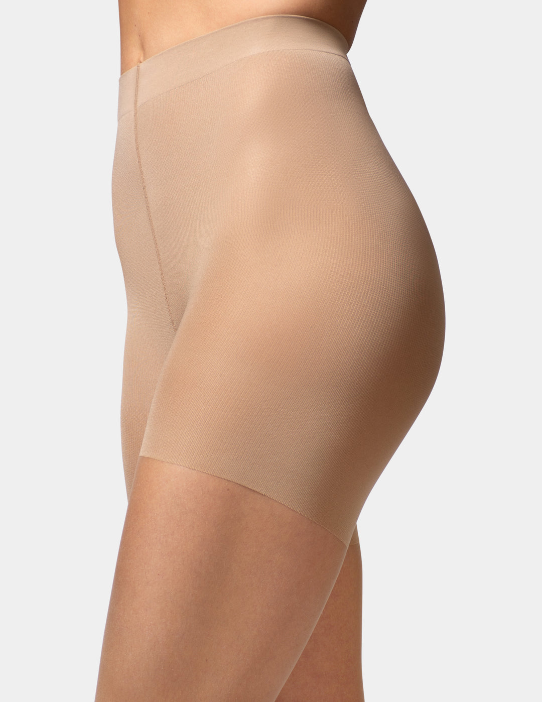 Close-up side view of a model wearing high-waisted sheers in a nude beige color, showing the ribbed texture and seamless waistband.