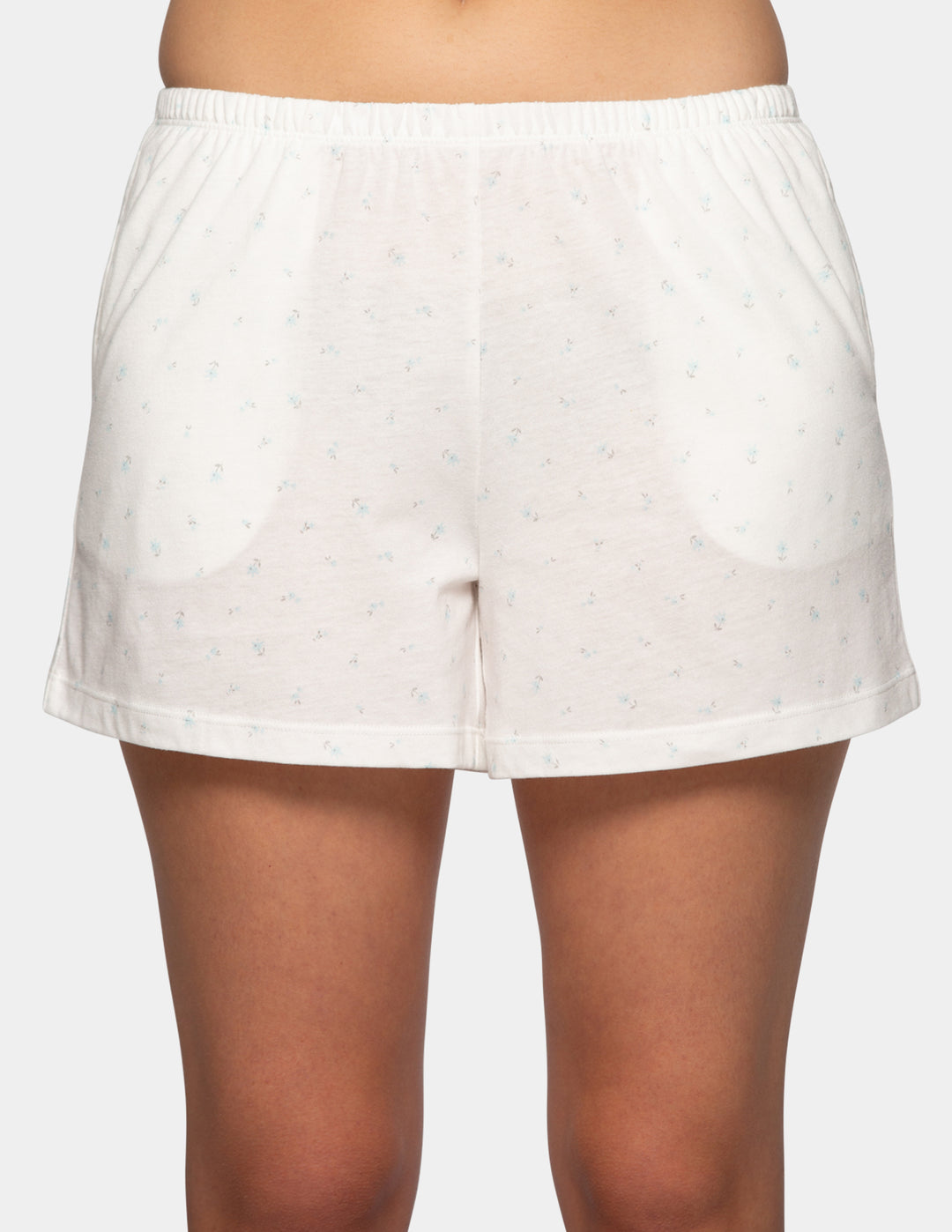 Woman wearing white pajama boxer shorts with blue flower details