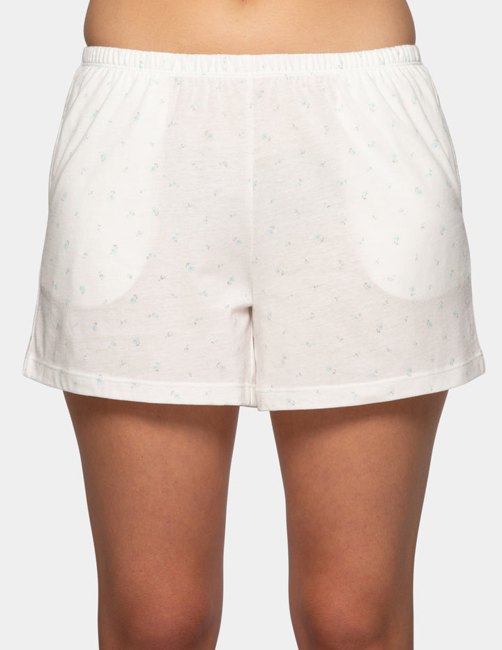 Woman wearing white pajama boxer shorts with blue flower details