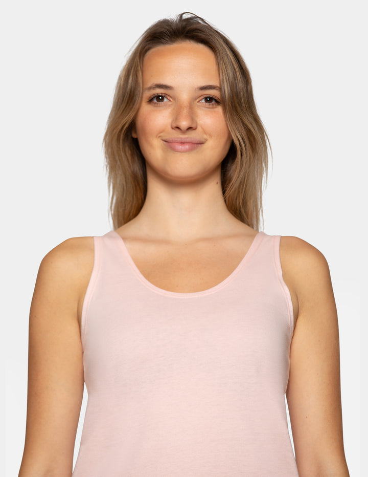 Woman wearing a light pink pajama tank top