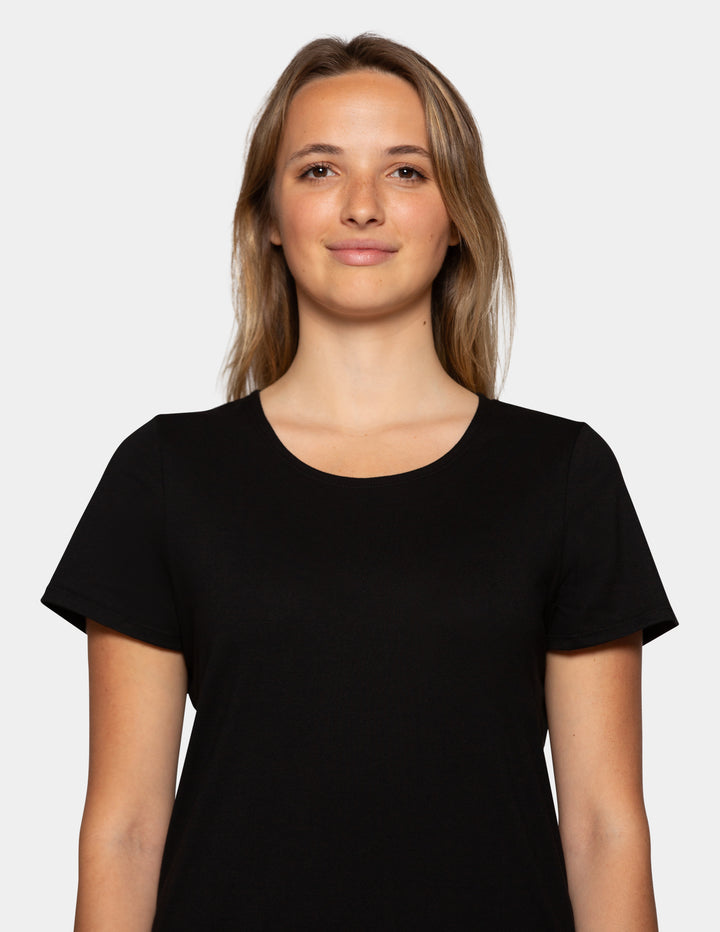 Woman wearing a black short sleeve pajama top