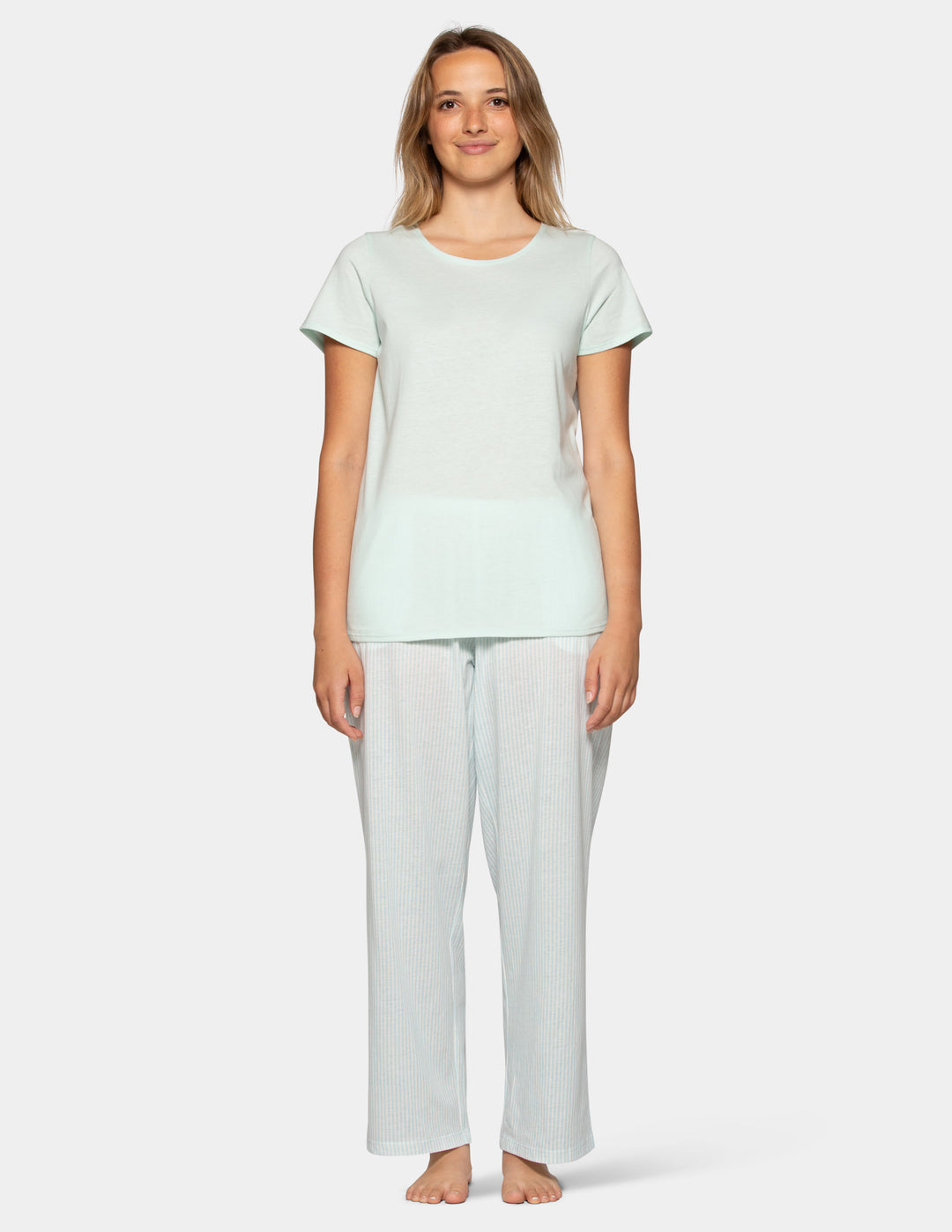 Woman wearing a pale blue pajama short sleeve tee and stripe pants set