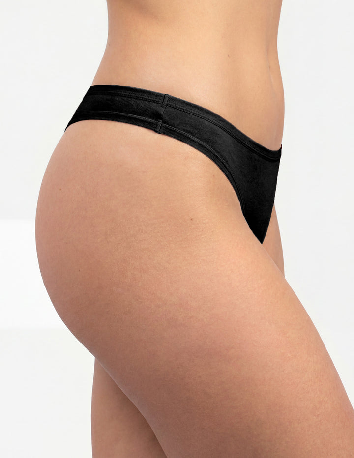 Woman wearing black thong underwear sideview
