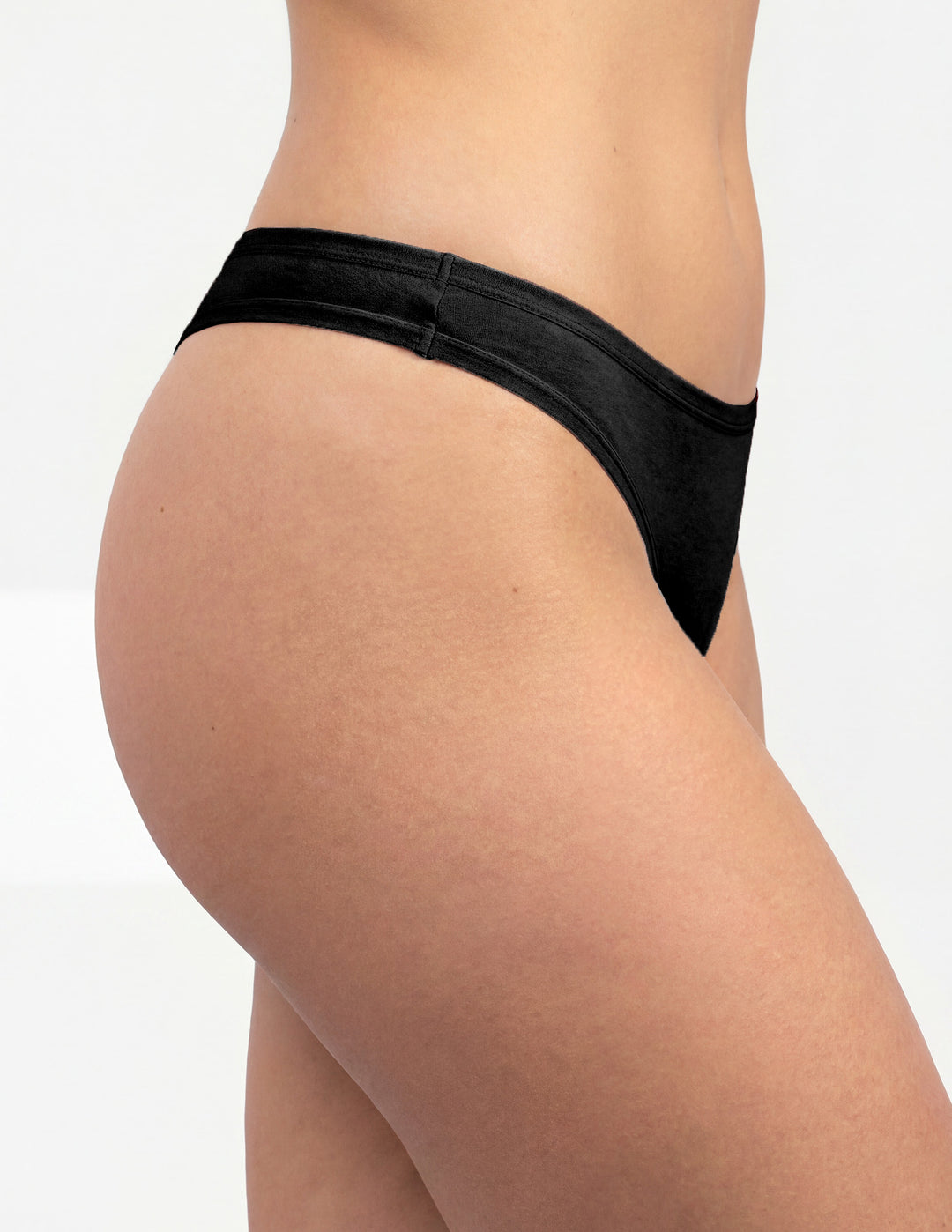 Woman wearing black thong underwear sideview