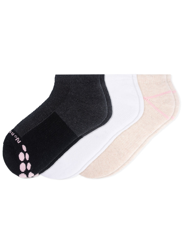 Three pairs of socks in black, white, and tan on a white background