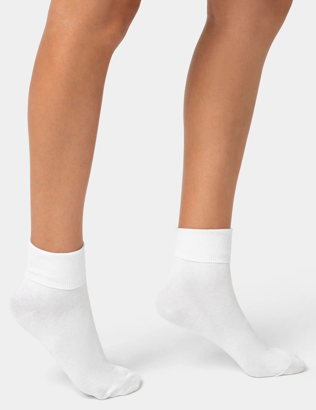 White socks worn by a person on a plain background