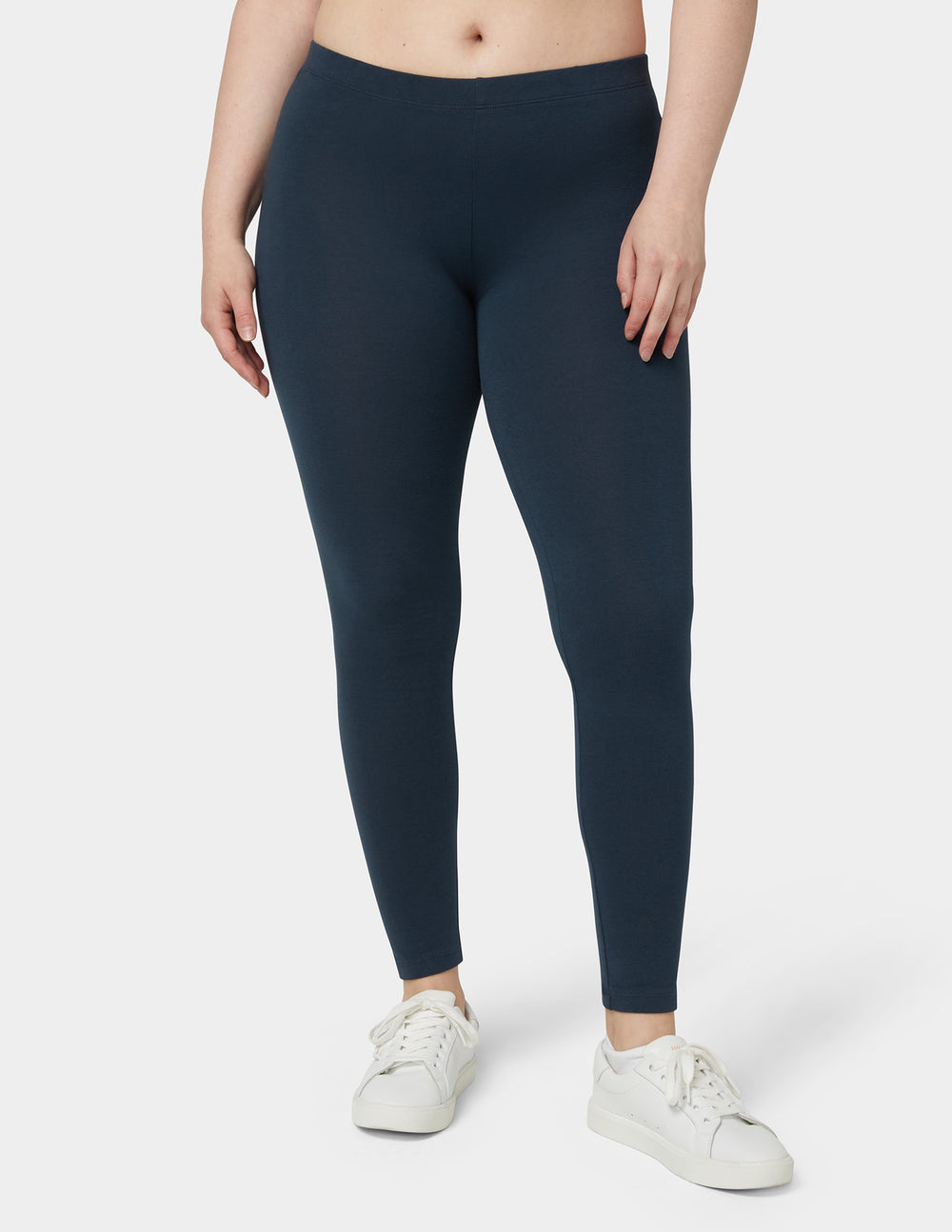 Navy leggings worn by a person on a white background