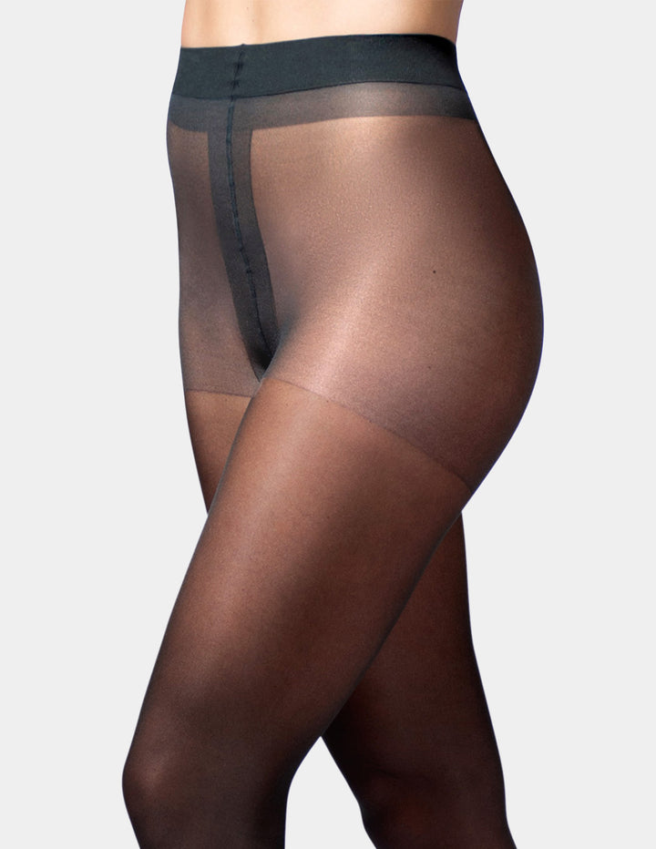 A side view of a model wearing sheer black thigh-high stockings with a wide waistband and a central seam detail, set against a plain light gray background.