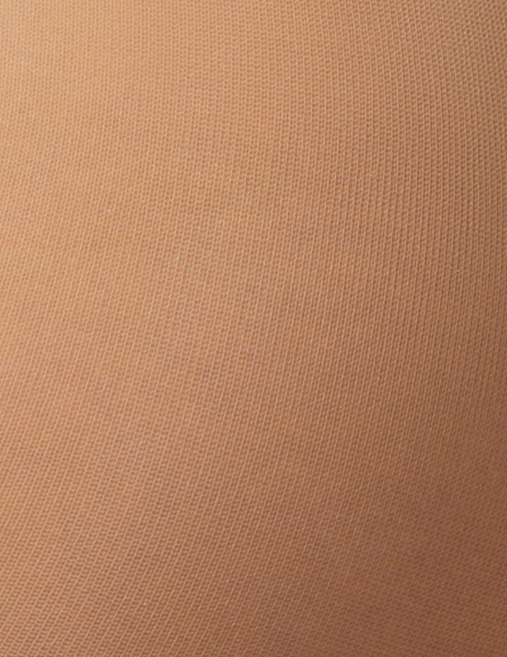 A close-up texture shot of a fine-knit fabric in a warm tan or camel color.