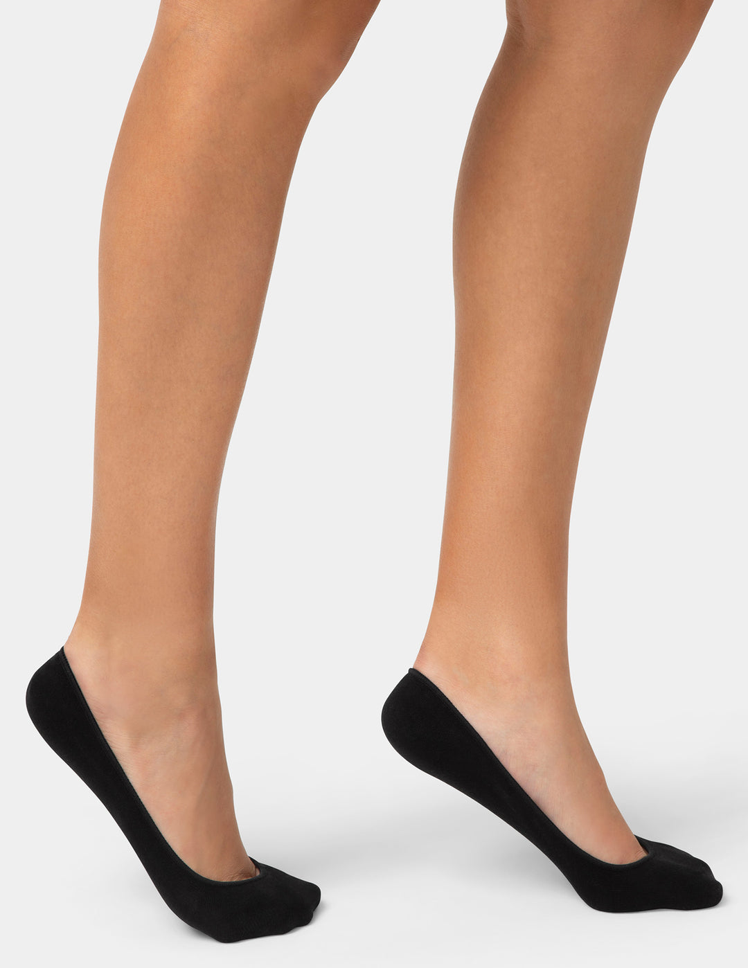 Black socks worn by a person on a white background