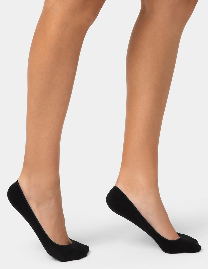 Black socks worn by a person on a white background