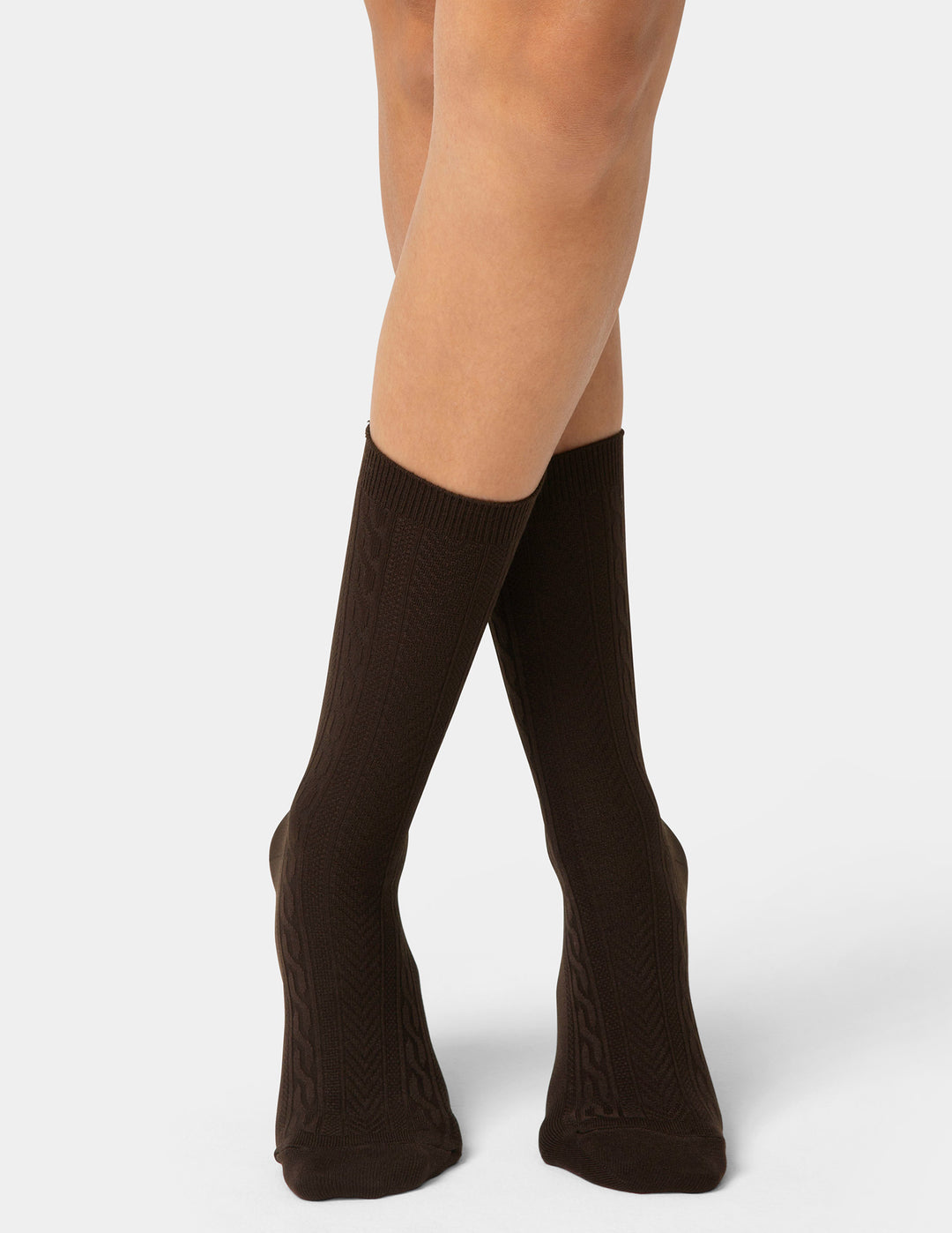 Brown knee-high socks worn by a person on a white background