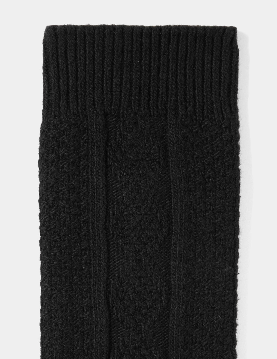 Close-up of black knitted socks on a white background