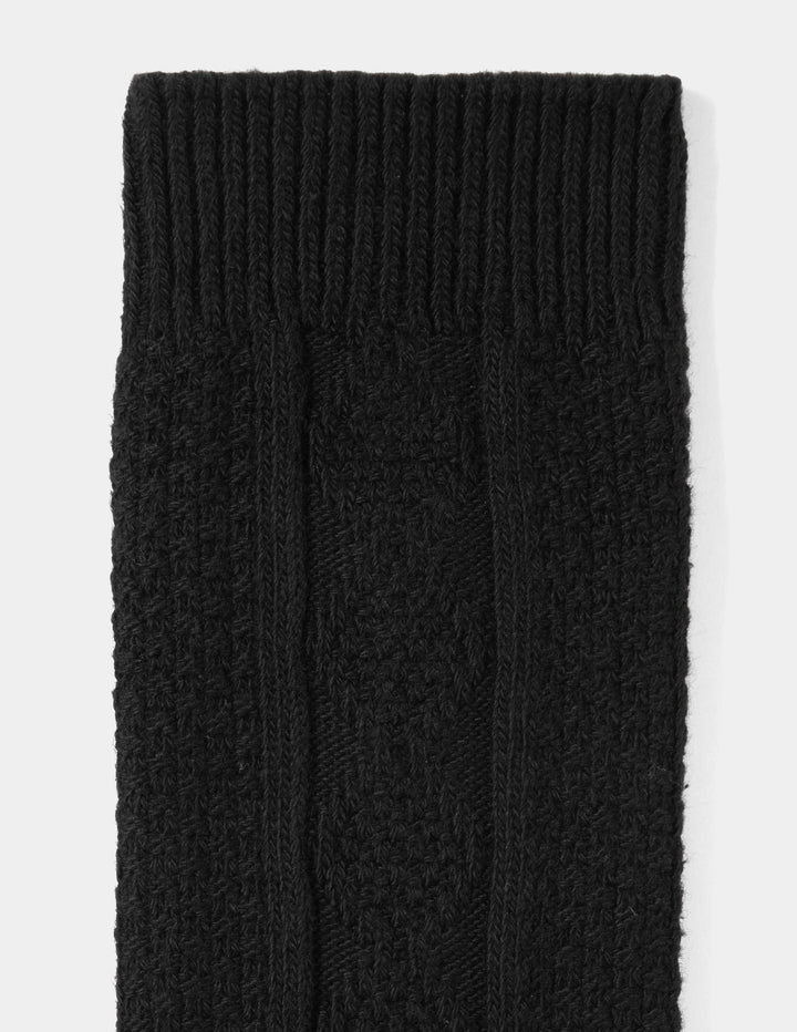 Close-up of black knitted socks on a white background