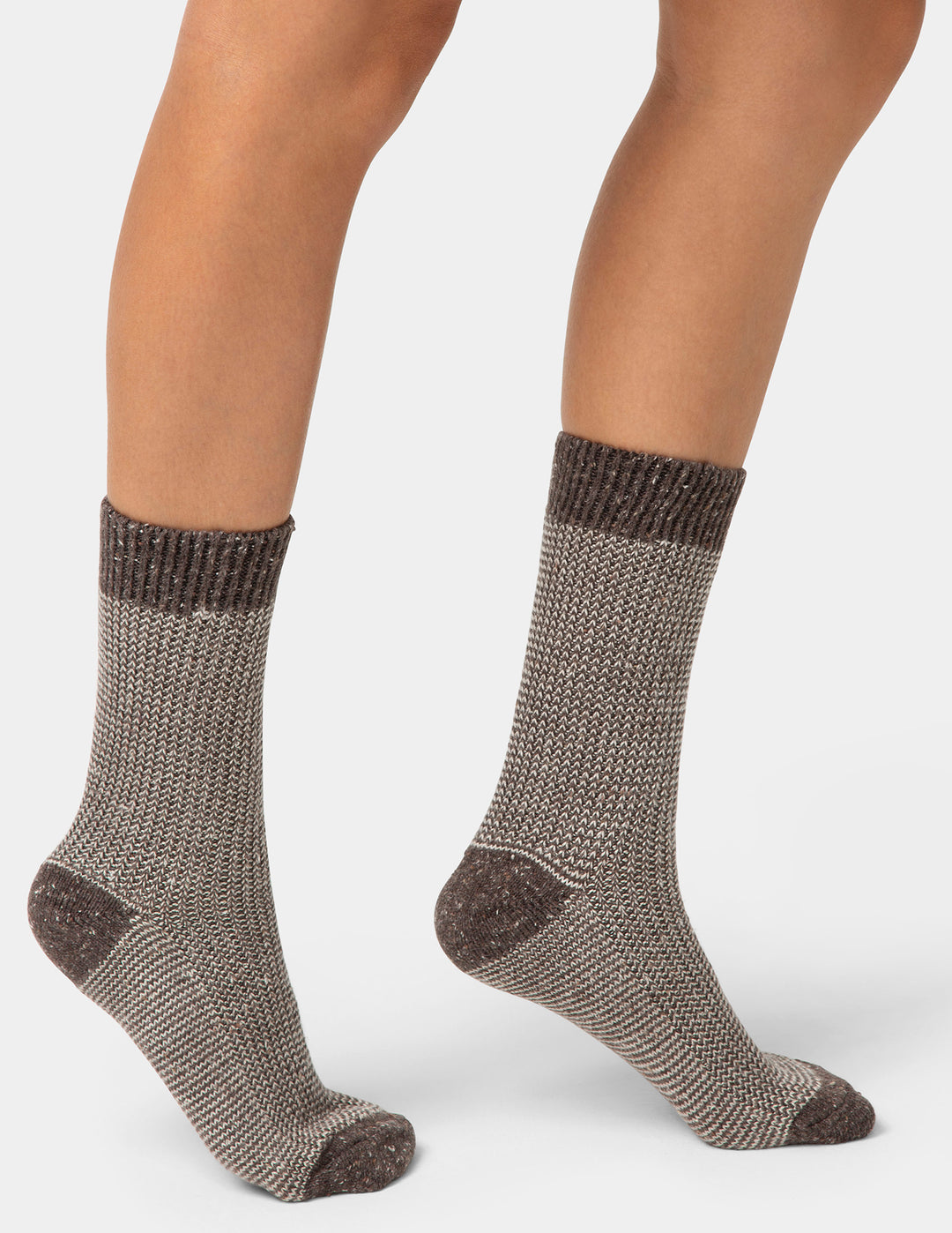 Brown textured socks worn by a person on a white background
