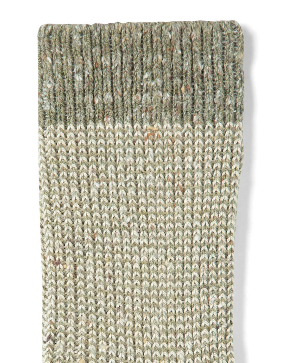 Textured green and beige rug on a white background