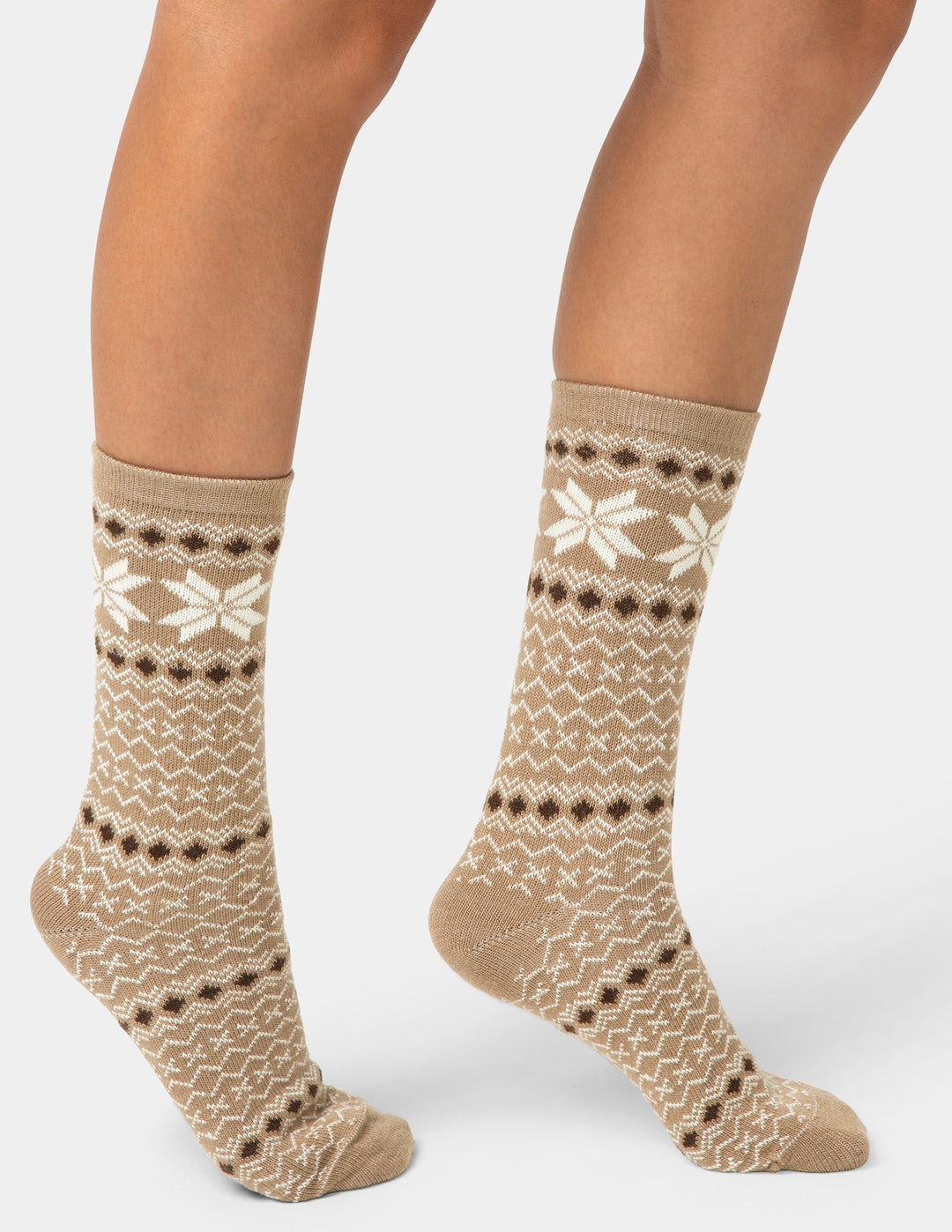 Beige patterned socks worn by a person on a white background