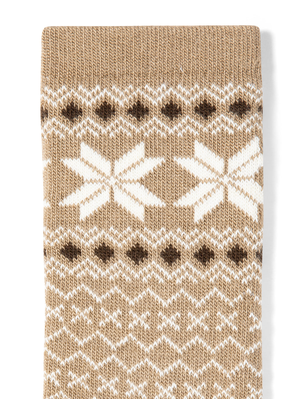 Knitted sock with a pattern of white snowflakes and brown dots on a beige background