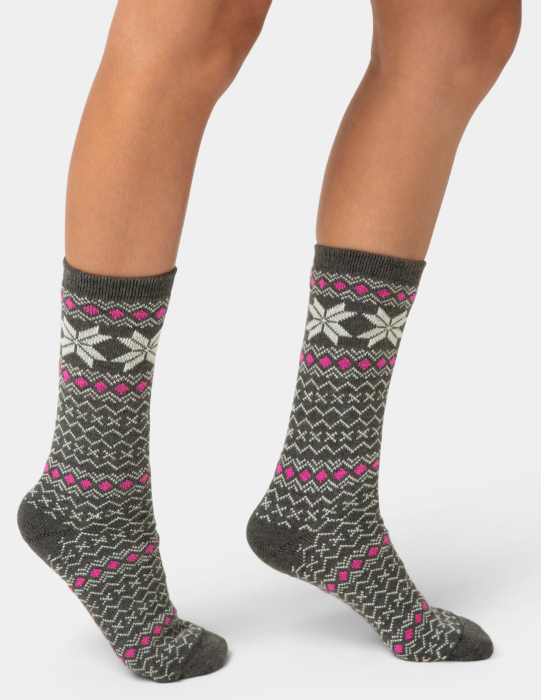 Gray socks with pink and white patterns worn by a person on a light gray background