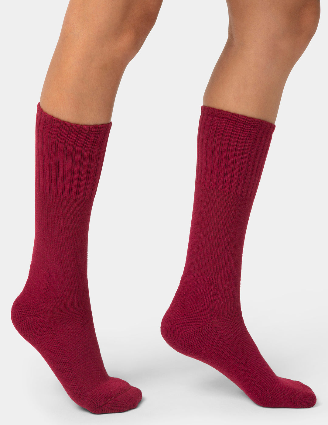 Red socks worn by a person on a white background