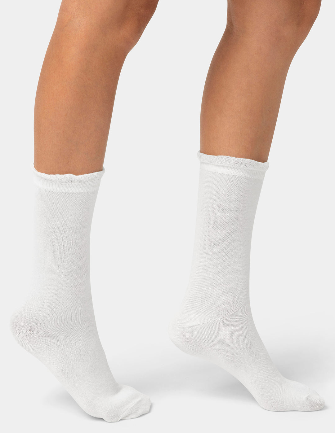 White socks worn by a person on a white background