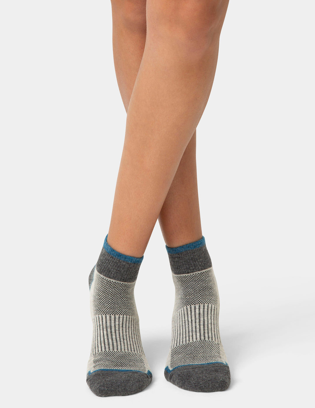 Gray socks with blue accents worn by a person on a white background
