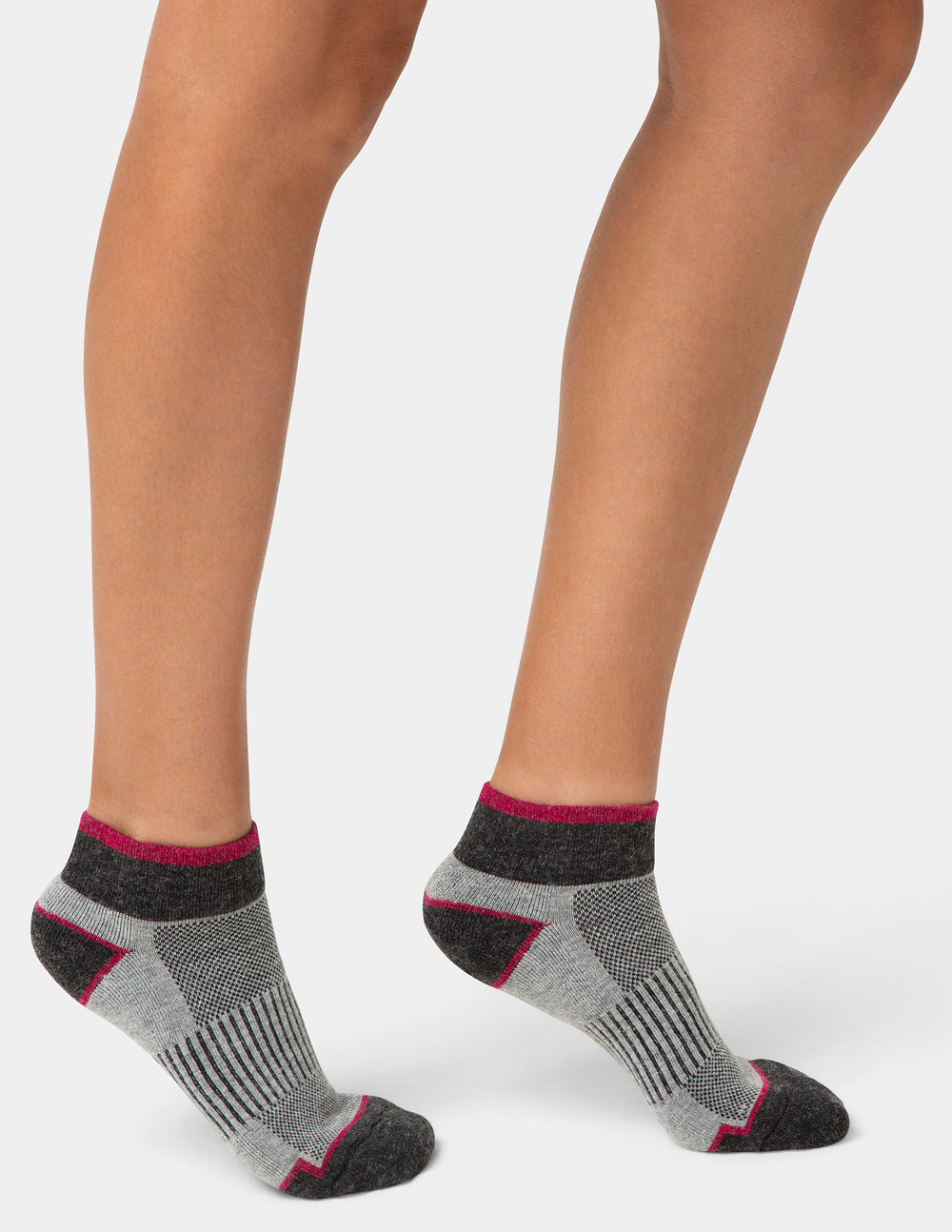Gray ankle socks with black and red accents worn by a person on a white background