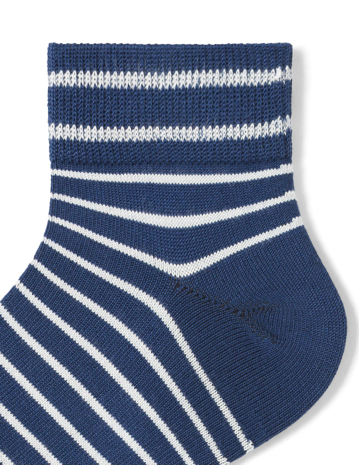 Blue and white striped sock on a light gray background