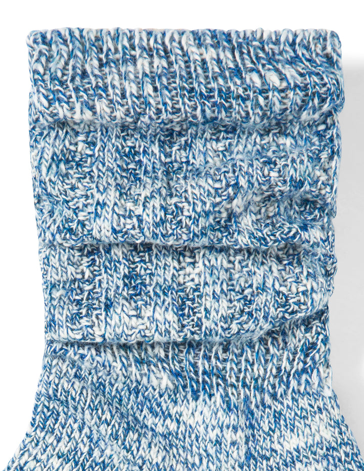 Blue and white marbled fabric roll on a white background