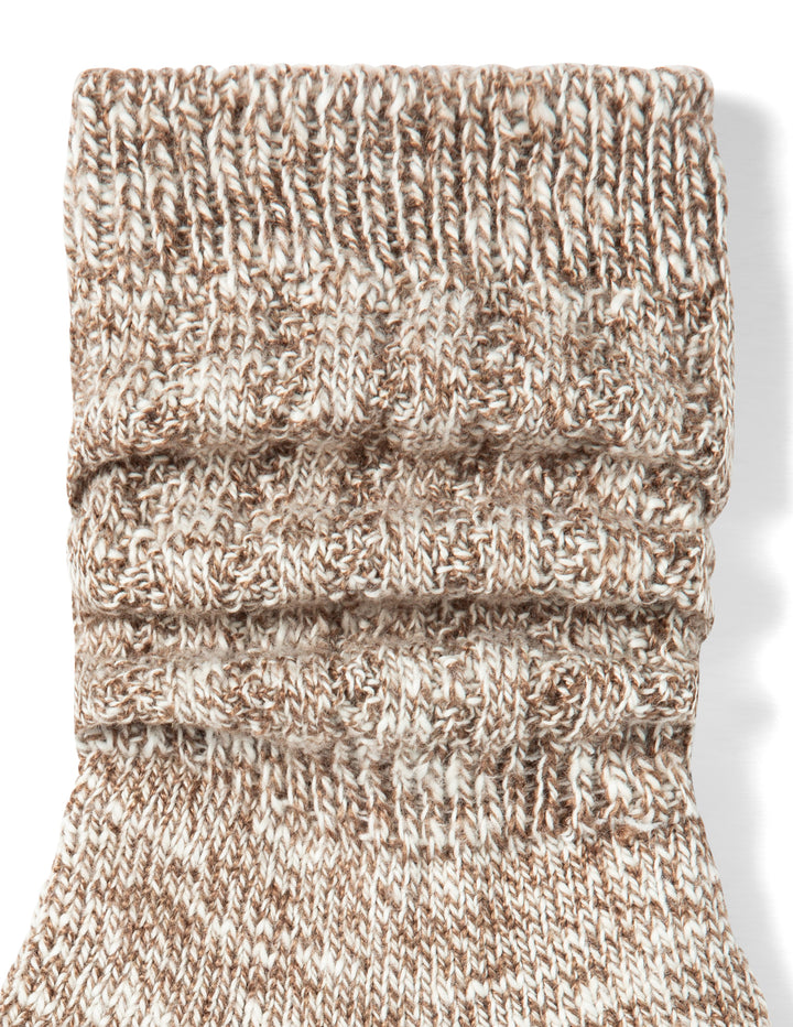 Knitted sock with a ribbed texture on a white background