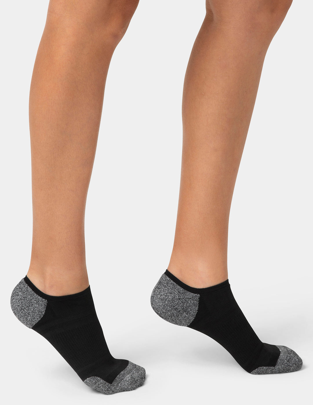 Black ankle socks with gray accents worn by a person on a white background