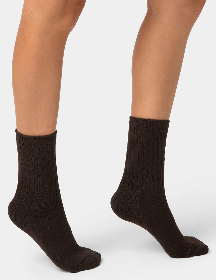 Brown socks worn by a person on a white background