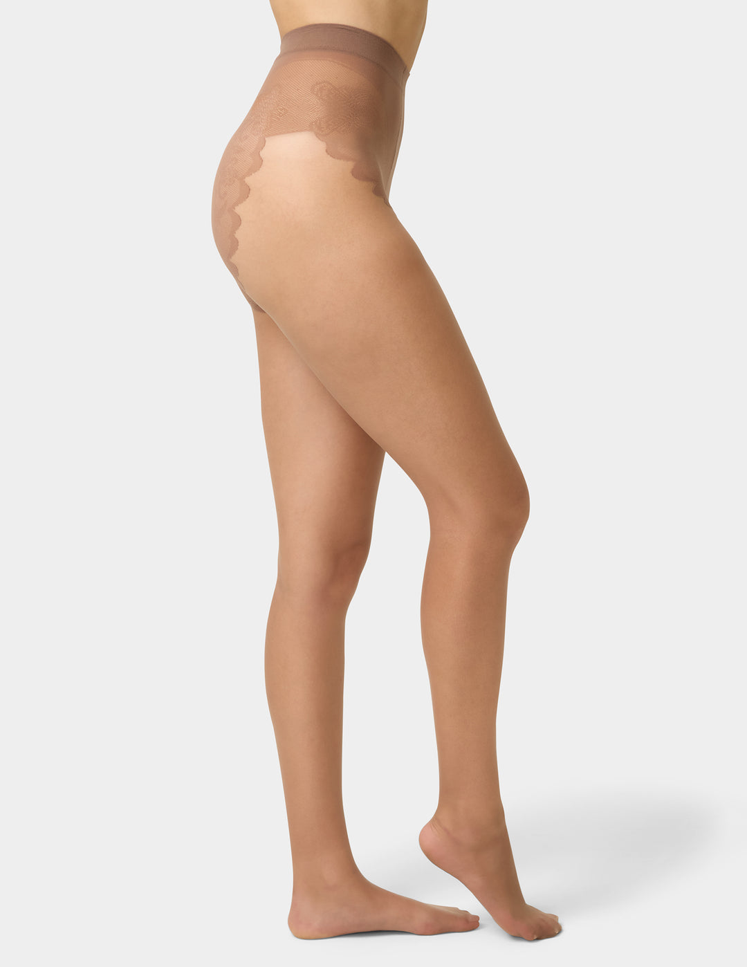 Beige sheer stockings being worn on a white background